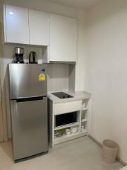 Compact modern kitchen with stainless steel appliances and white cabinetry