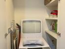 Compact and neat laundry room with storage shelves and a washing machine