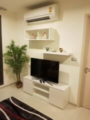 Cozy living room interior with television and shelves