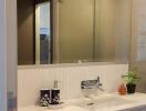 Modern bathroom interior with a well-lit vanity area and mirrored cabinets