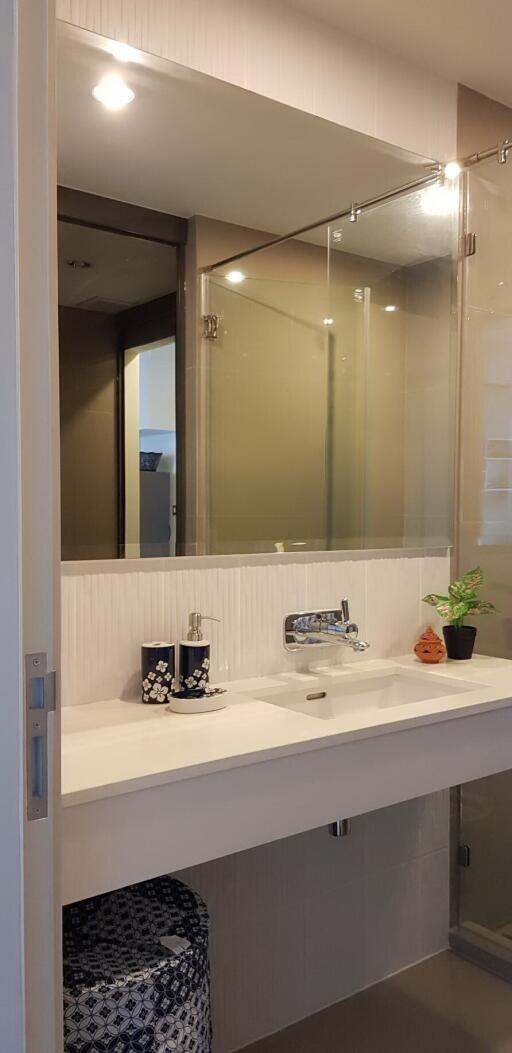 Modern bathroom interior with a well-lit vanity area and mirrored cabinets