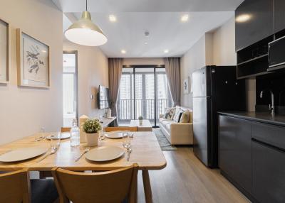 Modern open plan kitchen and dining area with adjacent cozy living room