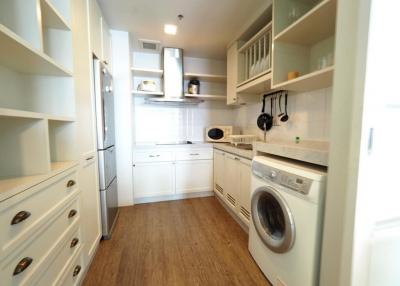 Modern kitchen with integrated appliances and wooden flooring