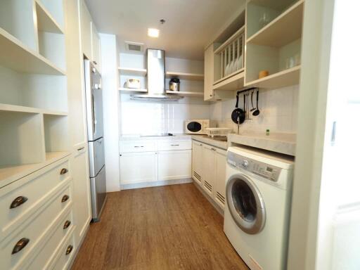 Modern kitchen with integrated appliances and wooden flooring