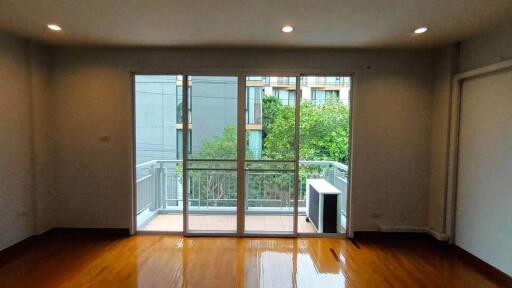 Spacious bedroom with large window and balcony access