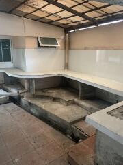 Unfinished kitchen with bare concrete structures and missing appliances