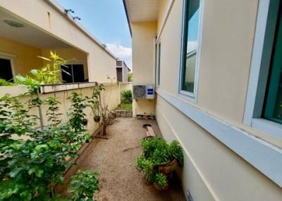 Suburban home backyard with air conditioning unit and potted plants