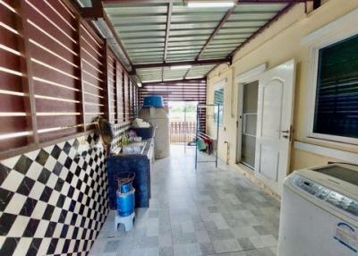Spacious covered patio with laundry area and outdoor furniture