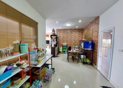 Spacious kitchen with brick accent wall and modern appliances