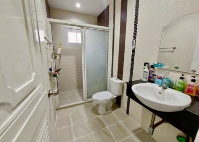 Modern bathroom with shower cubicle, toilet, and basin