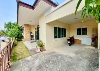 Spacious residential home front with driveway and motorcycle