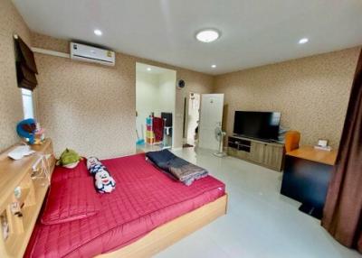 Spacious bedroom with modern amenities and large bed