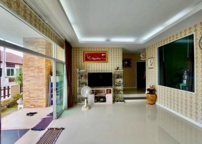 Spacious modern living room with tiled floors and decorative wallpaper