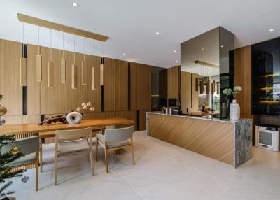 Modern kitchen and dining area with wooden accents and marble flooring
