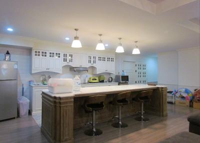 Spacious kitchen with modern island and bar stools
