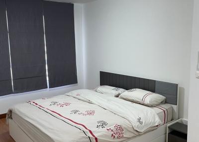 Modern bedroom with double bed and hardwood floors