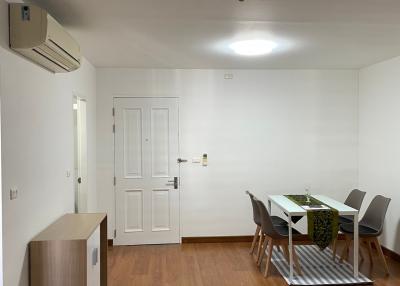 Bright and spacious dining area with a modern table set and wooden flooring