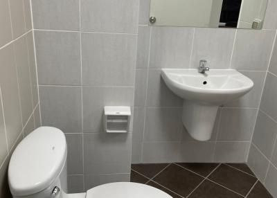 Modern bathroom with white fixtures and tile walls