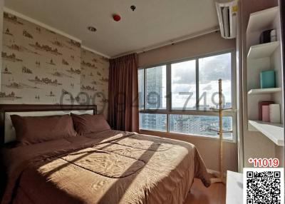 Cozy bedroom with natural light and city view