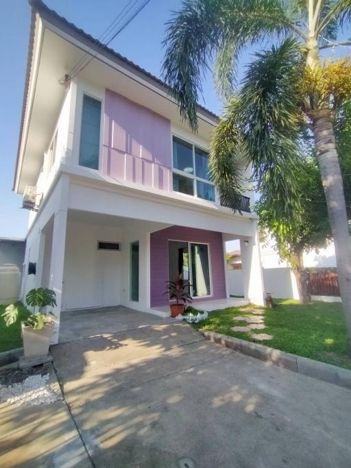 Suburban two-story house with front yard and palm trees