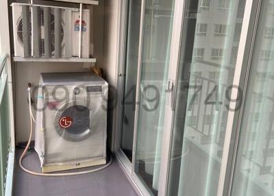 Enclosed balcony with washing machine and utility shelf