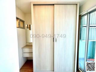 Compact entryway with closed sliding door and small shelf unit