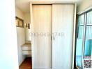 Compact entryway with closed sliding door and small shelf unit