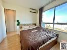 Cozy bedroom with a large window and ample sunlight