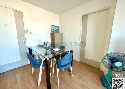 Bright dining area with a glass table and blue chairs