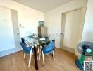 Bright dining area with a glass table and blue chairs