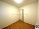 Empty bedroom with wooden floor and white walls