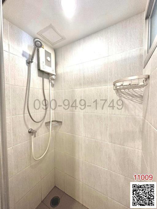 Modern tiled bathroom with shower and water heater