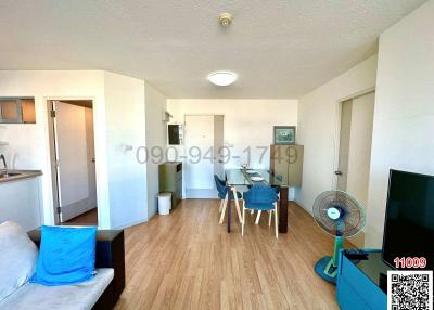 Bright and spacious living room with dining area and wooden flooring