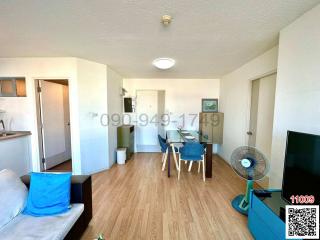 Bright and spacious living room with dining area and wooden flooring