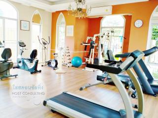 Home fitness gym with modern equipment and bright interior