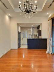 Modern kitchen with hardwood floors and chandelier