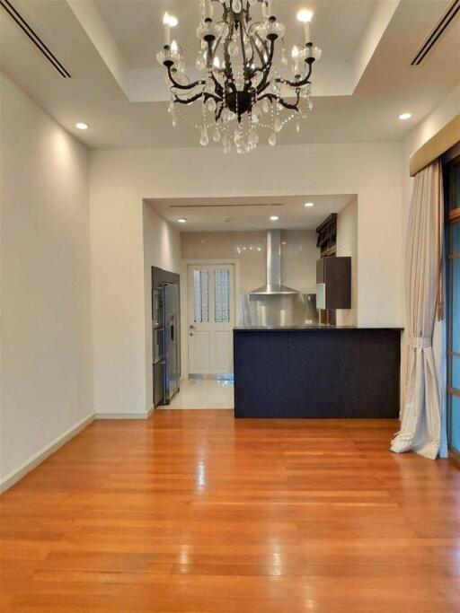 Modern kitchen with hardwood floors and chandelier