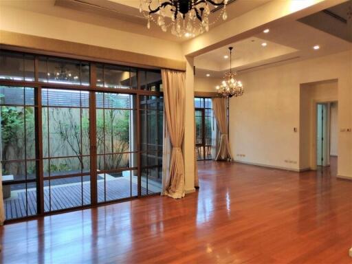 Spacious and elegant living room with hardwood floors and large windows