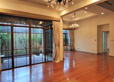 Spacious and elegant living room with hardwood floors and large windows