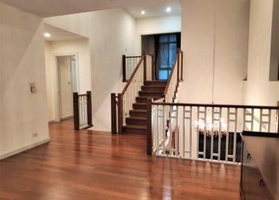 Open concept living space with hardwood floors and staircase