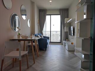 Modern living room with dining area and balcony access