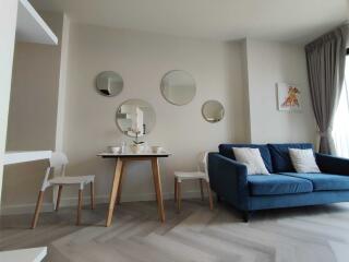 Contemporary living room with blue sofa and wooden table