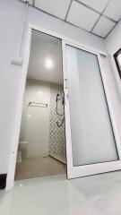 Modern bathroom with glass shower door and white interior