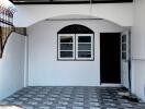 Modern residential garage interior with tiled floor and ample natural light