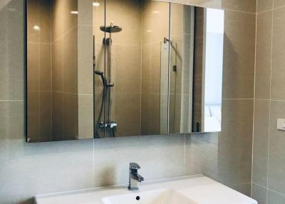 Modern bathroom with glass shower and large mirror