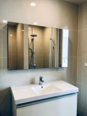 Modern bathroom with glass shower and large mirror