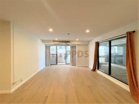 Spacious living room with natural lighting and balcony access