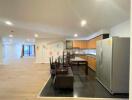 Spacious open plan kitchen and dining area with modern appliances and ample lighting