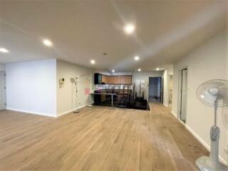 Spacious living room with open floor plan connecting to kitchen