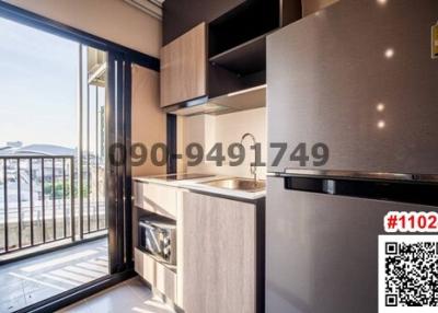 Modern kitchen with stainless steel appliances and balcony access